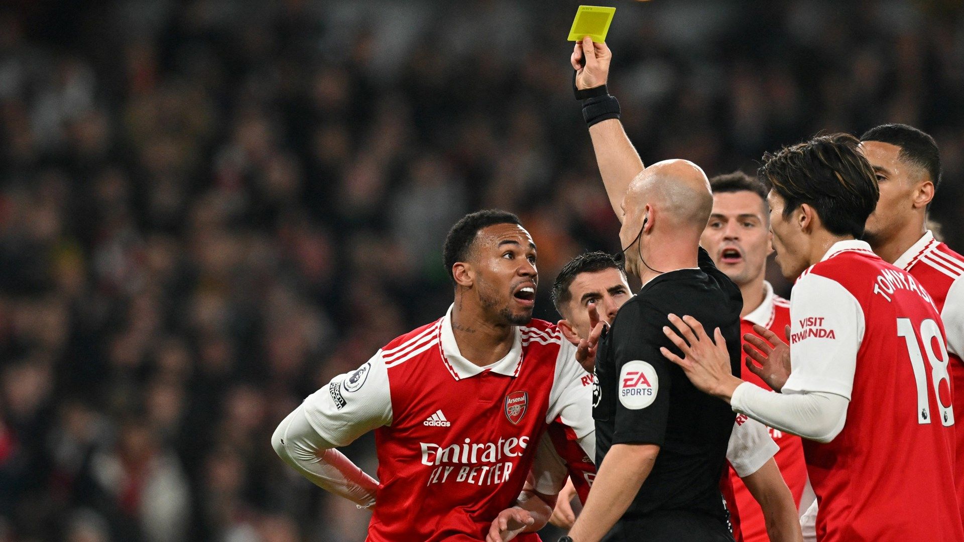 Gabriel Magalhaes is shown a yellow card by referee Anthony Taylor during Arsenal's defeat to Manchester City in 2022-23 Premier League
