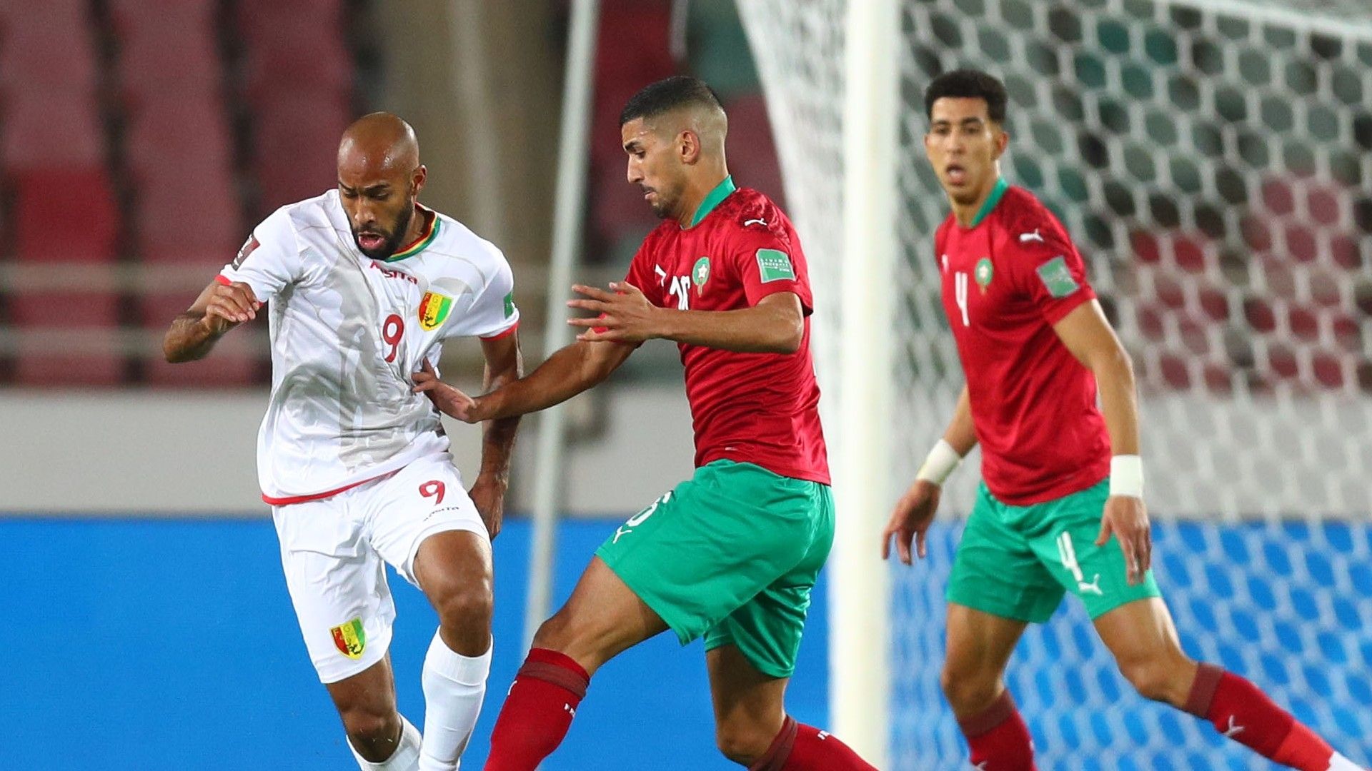 Jose Kante of Guinea is challenged by Aymen Barkok of Morocco