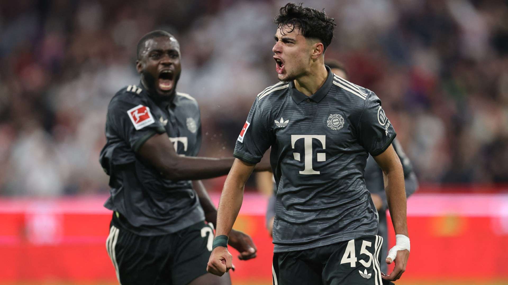 Bayern Munich's German midfielder #45 Aleksandar Pavlovic (R) celebrates scoring