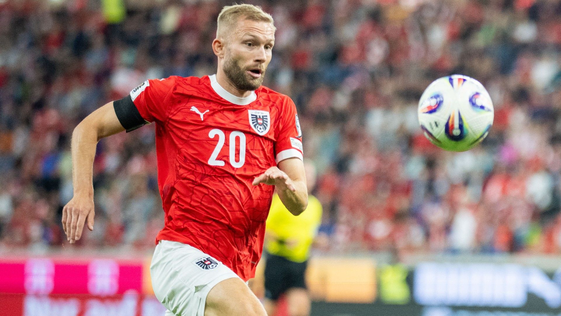 Austria's midfielder #20 Konrad Laimer eyes the ball 