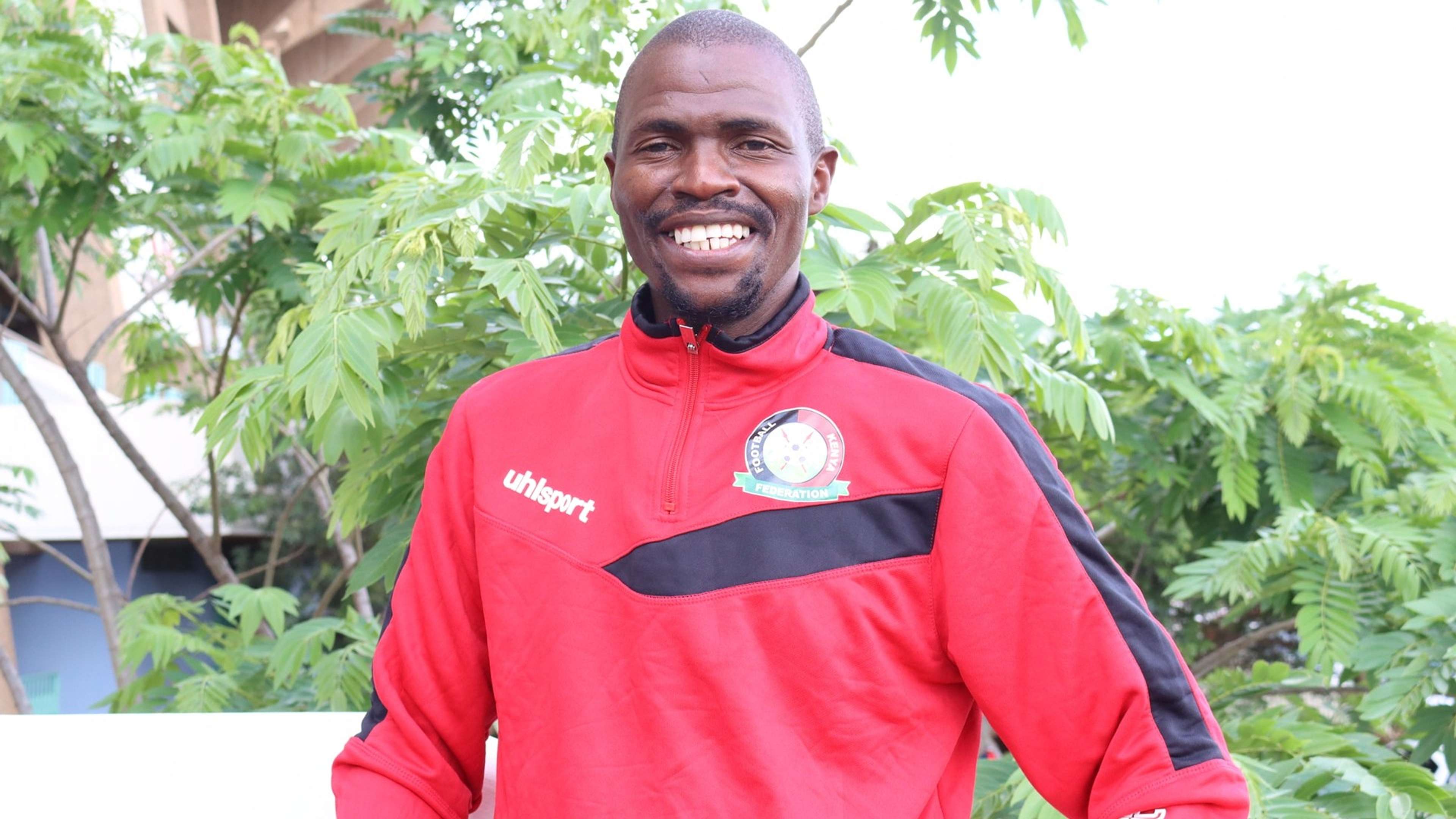 Charles Okere as the Harambee Starlets head coach.