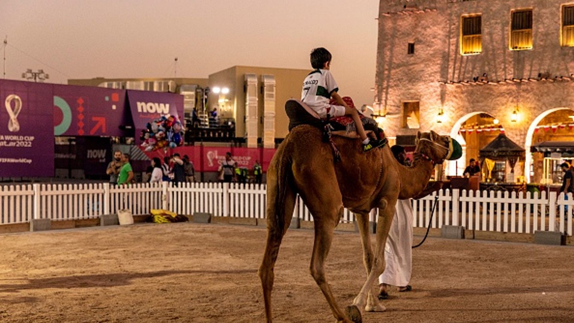  A boy rides a camel at Souq Waqif ahead of the FIFA World Cup Qatar 2022