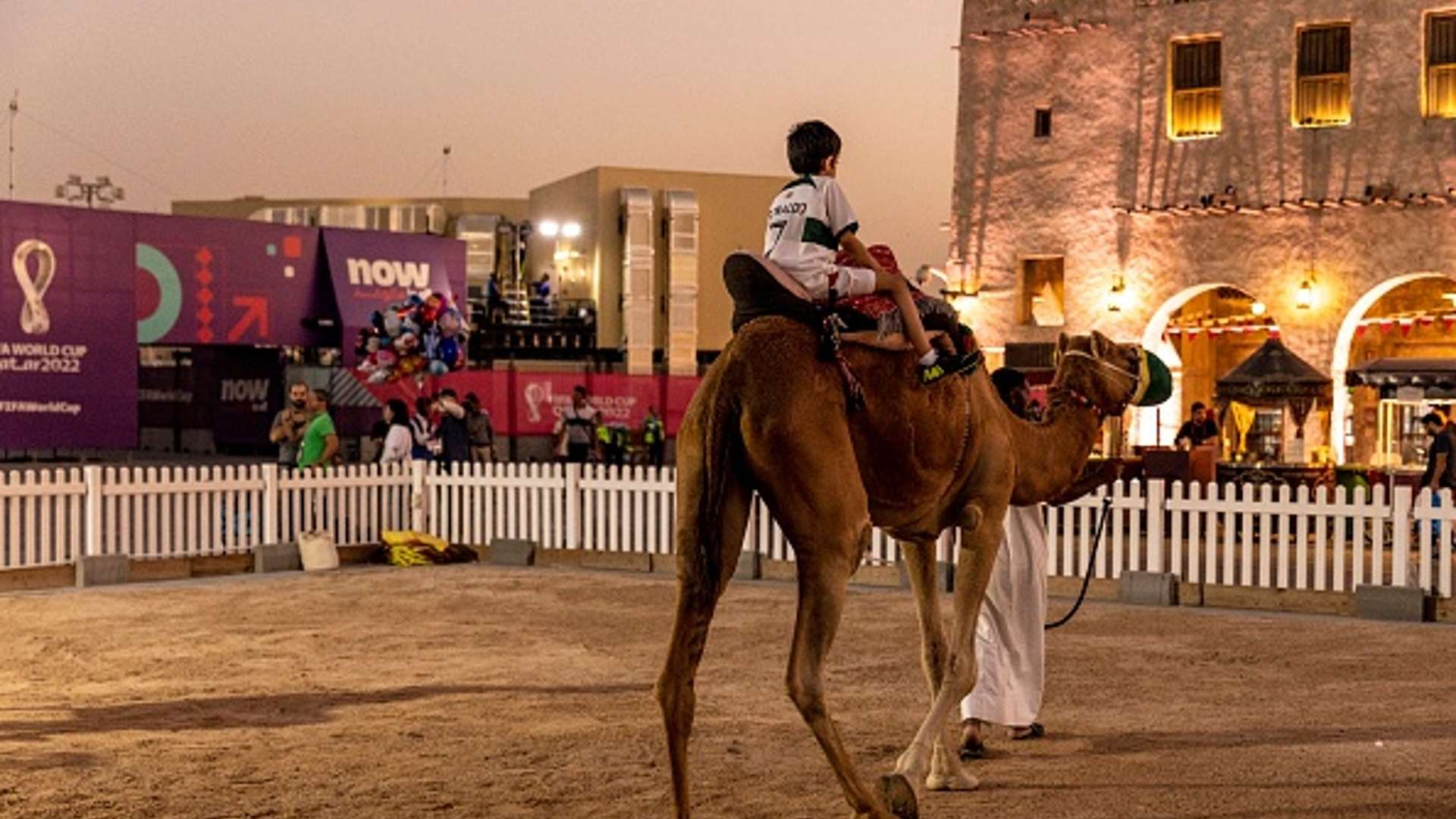 A boy rides a camel at Souq Waqif ahead of the FIFA World Cup Qatar 2022