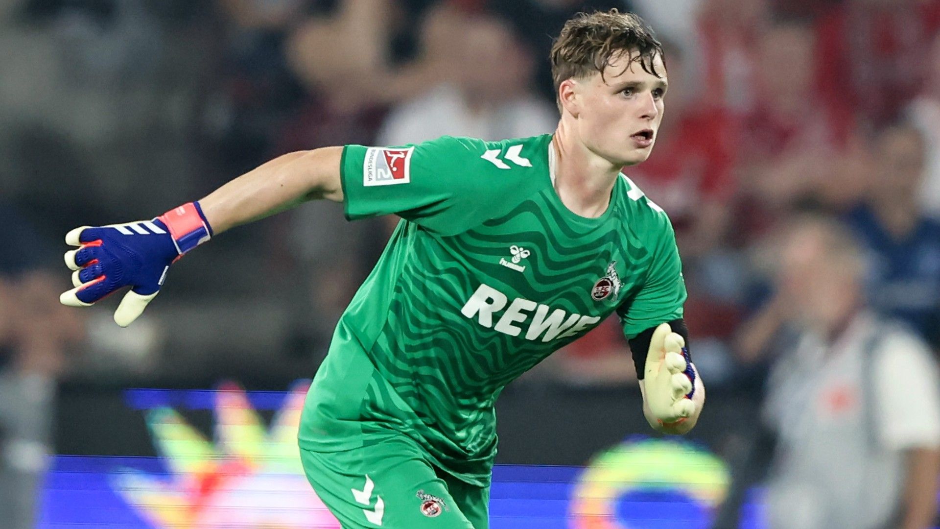  Jonas Urbig of 1. FC Koeln runs with the bal