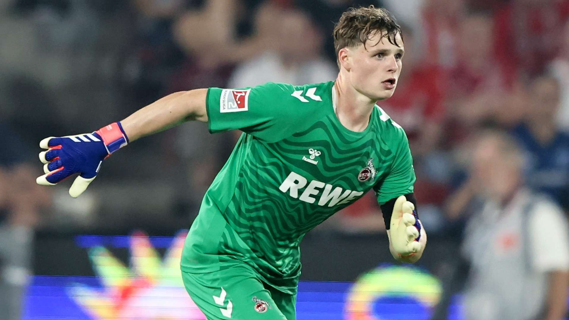 Jonas Urbig of 1. FC Koeln runs with the bal