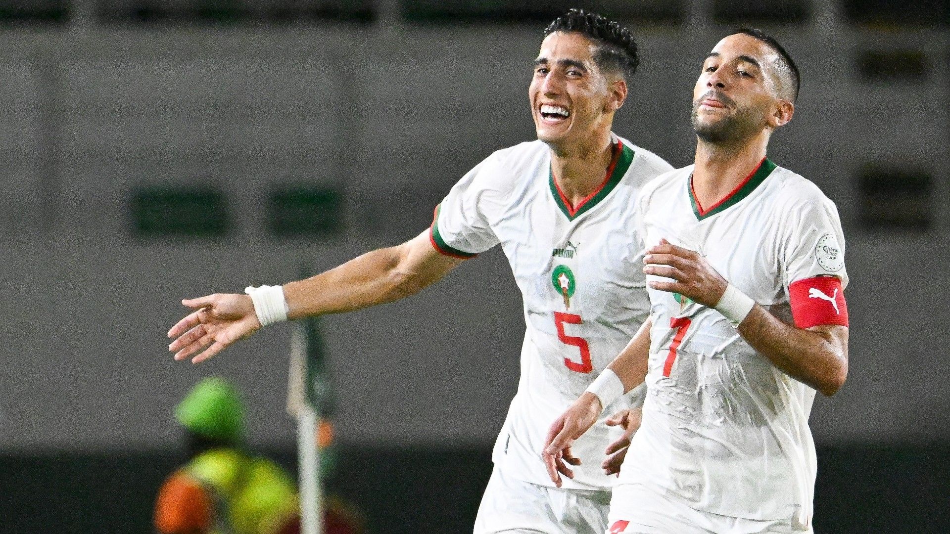 Morocco's midfielder #7 Hakim Ziyech (R) celebrates with Morocco's defender #5 Nayef Aguerd