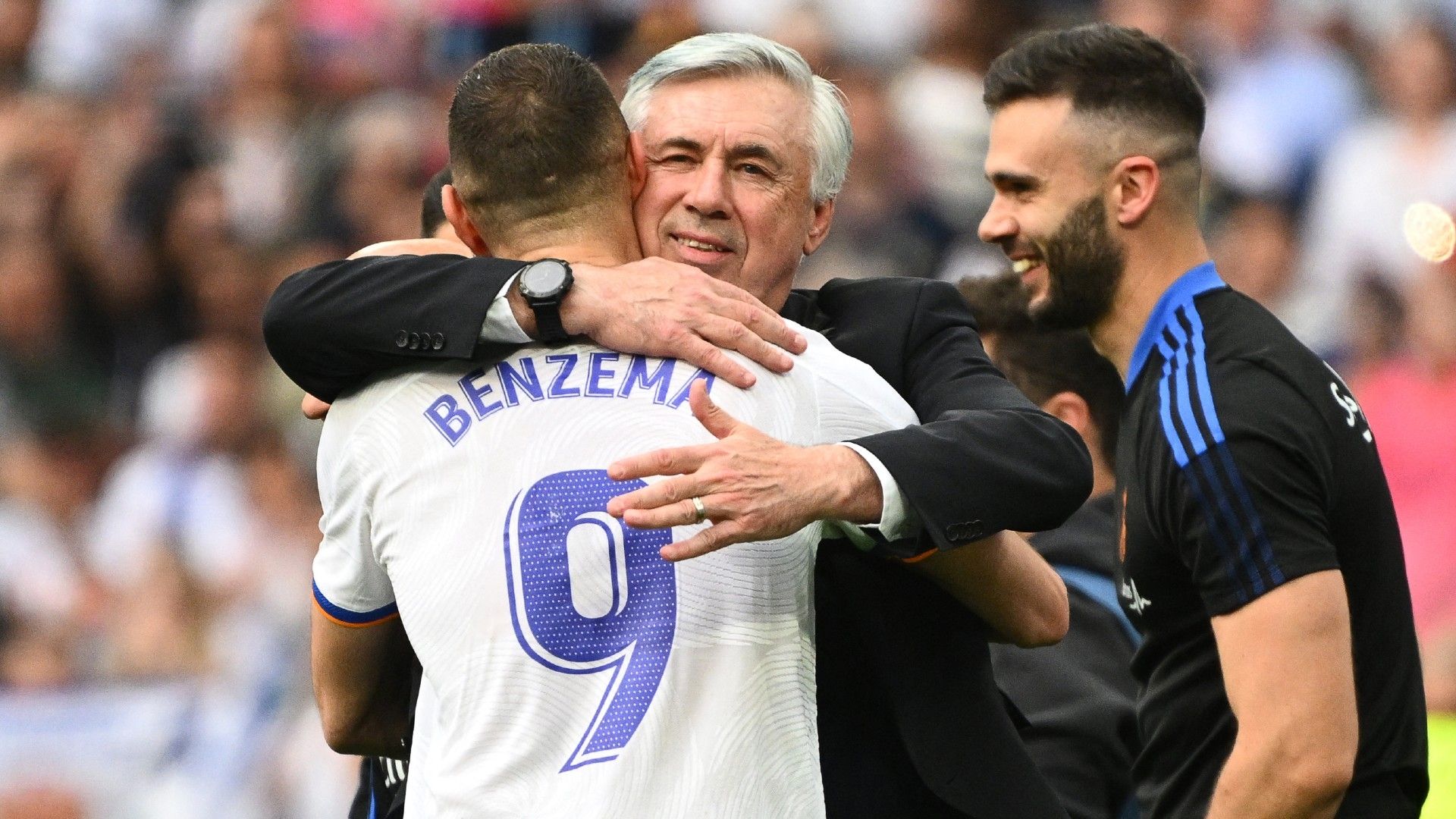 Real Madrid's French forward Karim Benzema (L) hugs Real Madrid's Italian coach Carlo Ancelotti