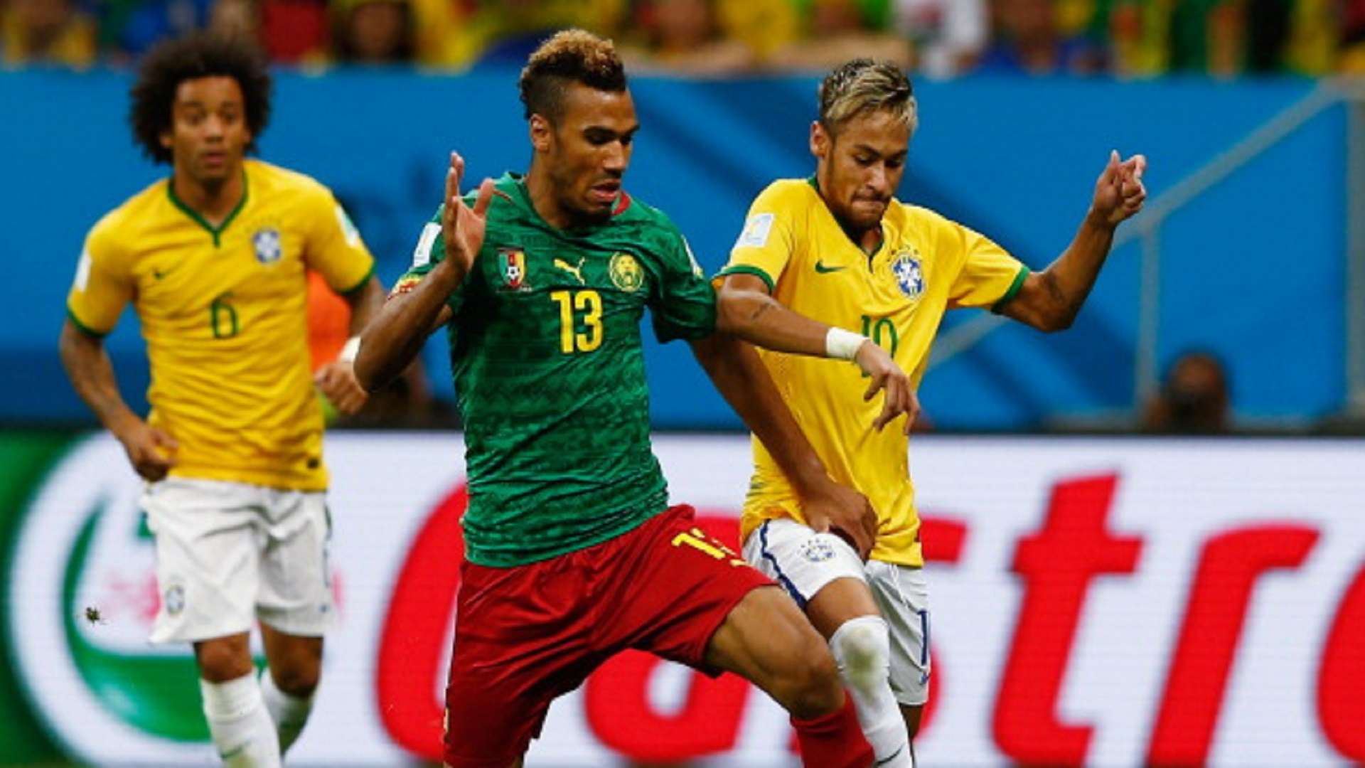 Maxim Choupo-Moting of Cameroon battles with Neymar of Brazil during the 2014 FIFA World Cup Brazil