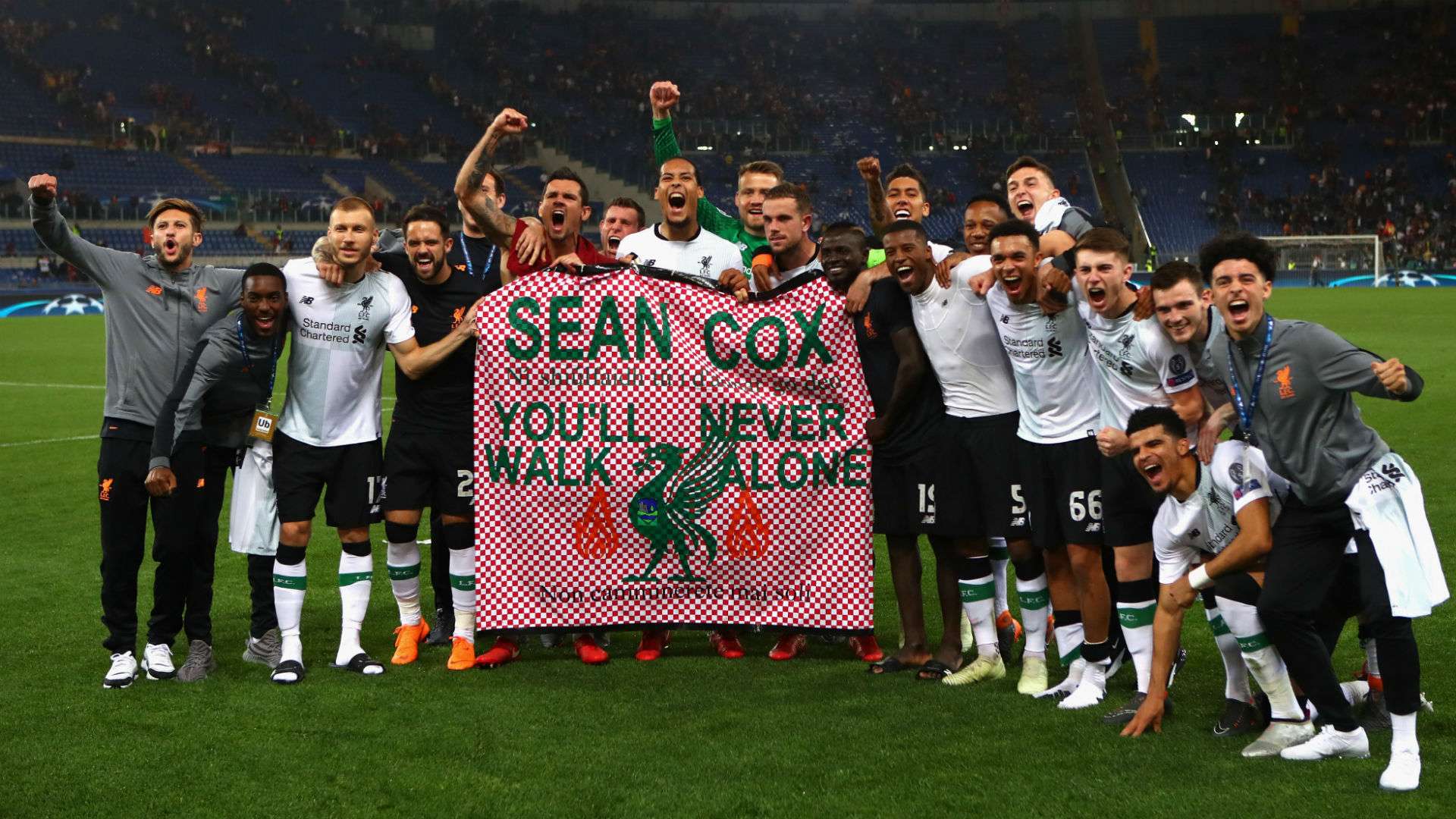 Liverpool fans hold a banner in tribute to injured fan Sean Cox