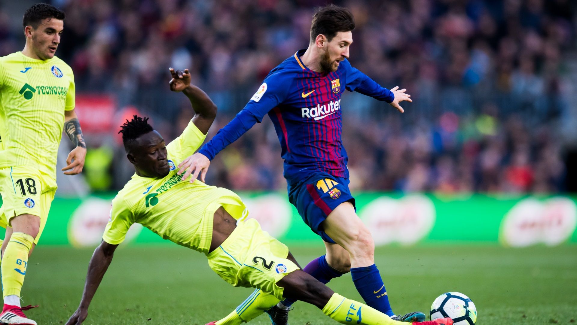 Djene Dakonam of Getafe, and Barcelona's Lionel Messi