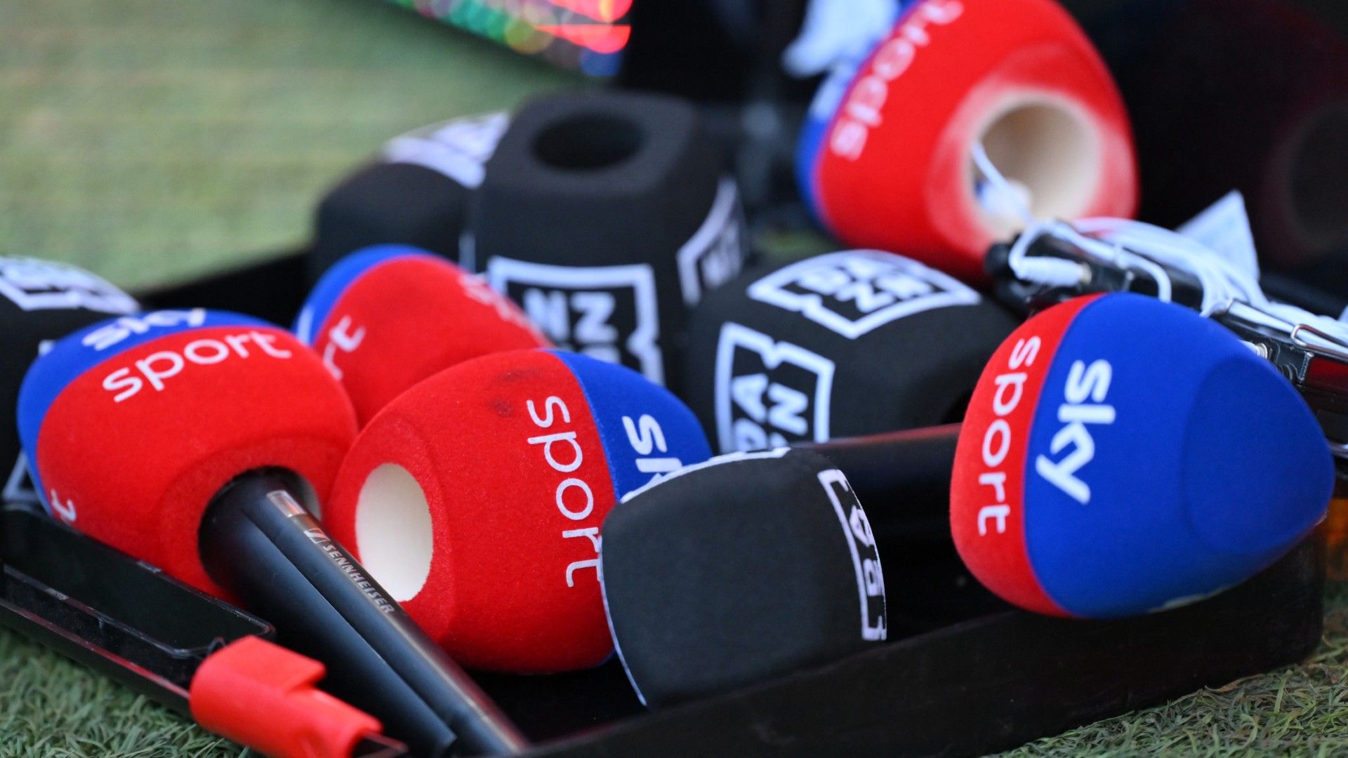 Several microphone covers of sky sports and DAZN lie next to each other 