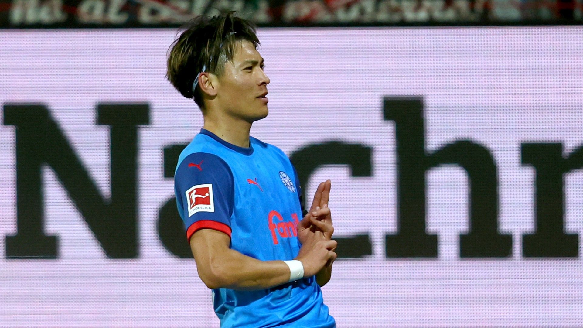 Shuto Machino of Holstein Kiel celebrates scoring 