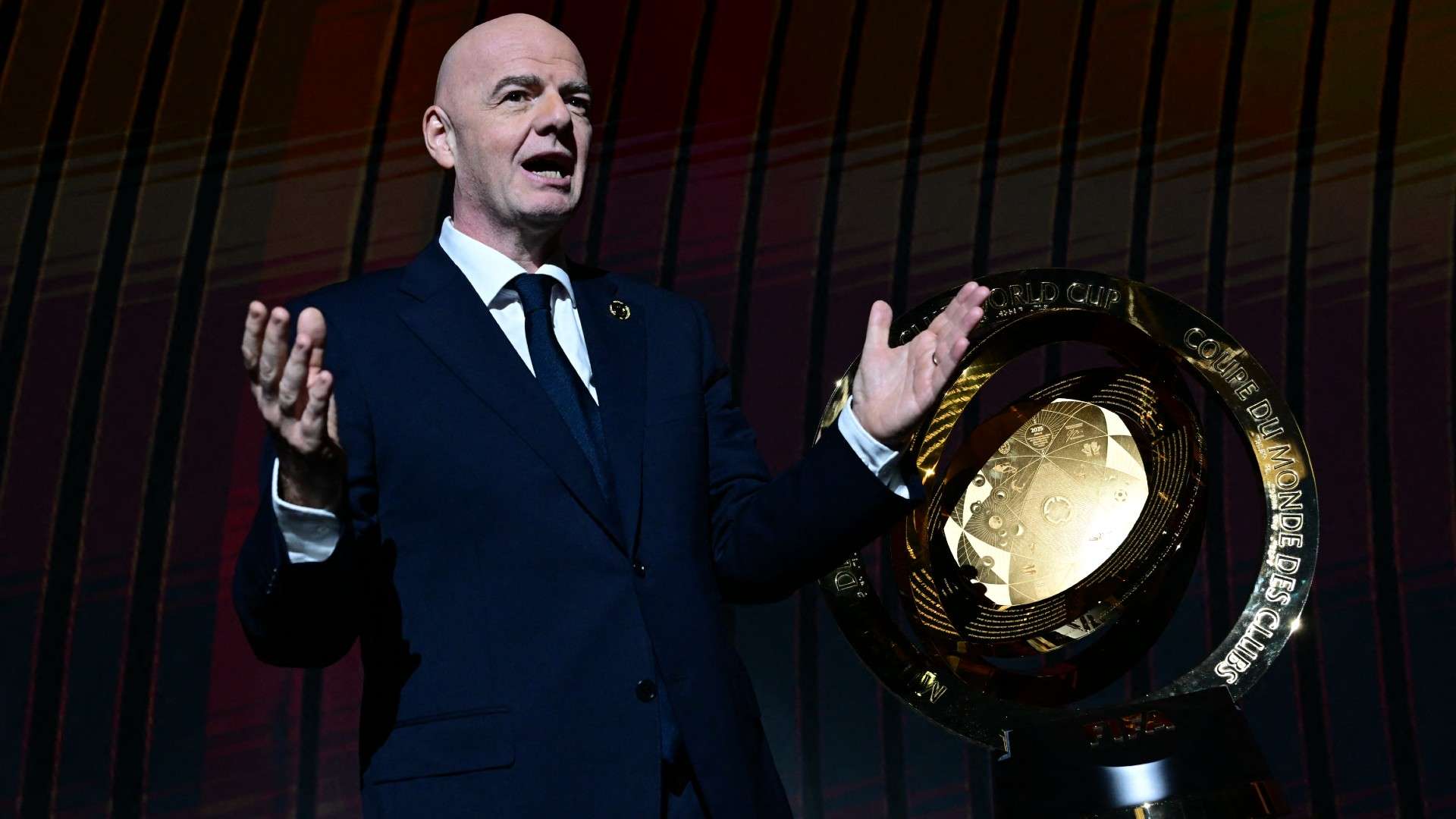 President of FIFA Gianni Infantino speaks next to the trophy during the 2025 FIFA Club World Cup Draw ceremony