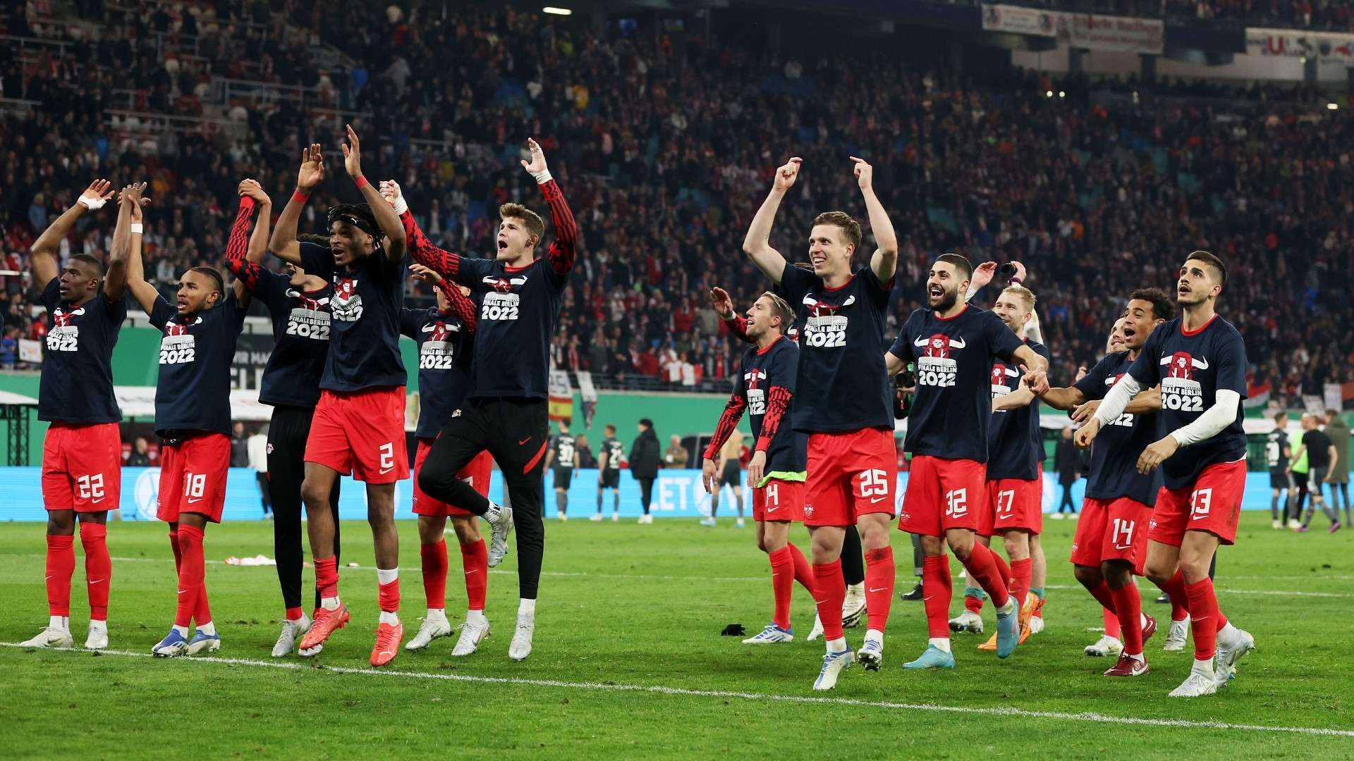 Players of RB Leipzig celebrate their side's victory whilst wearing Finale Berlin 2022