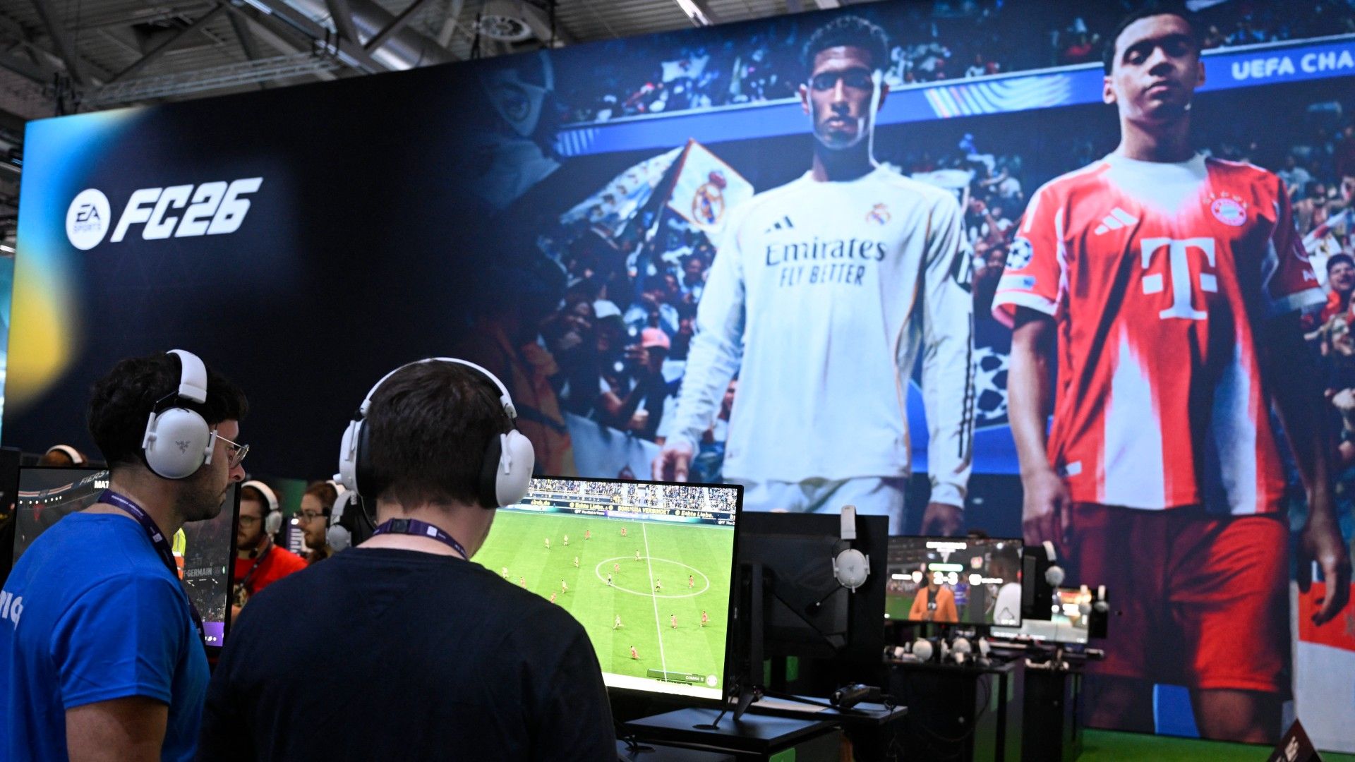 Gamers play the video game EA Sports FC 26 in front of a screen