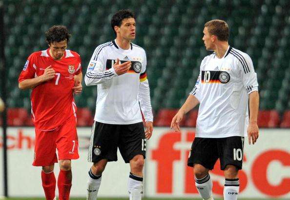 Germany's midfielder Michael Ballack (C) has a disagreement with Germany's striker Lukas Podolski (R)