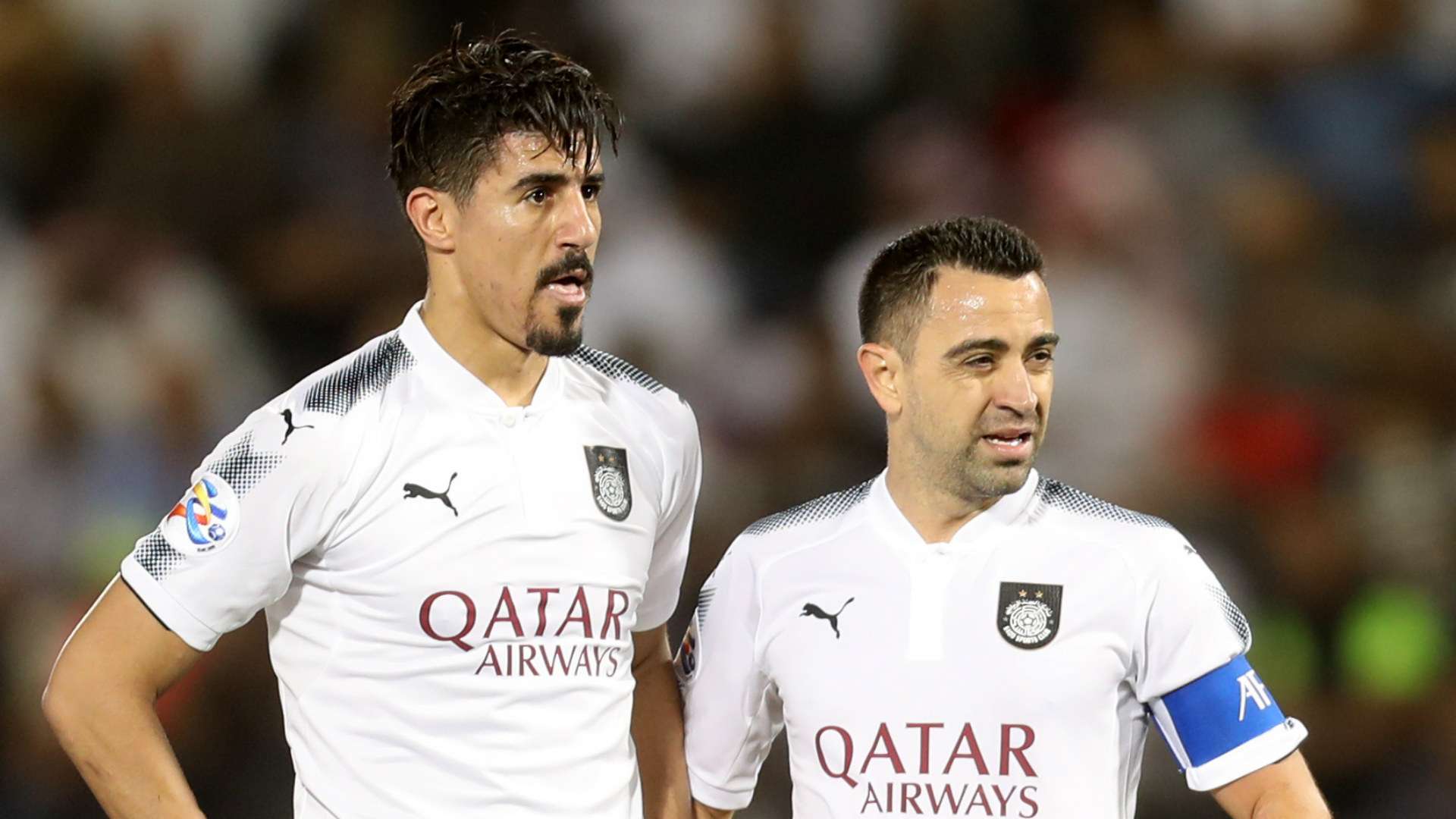 Bounedjah and Xavi Hernandez, in a Al Sadd game
