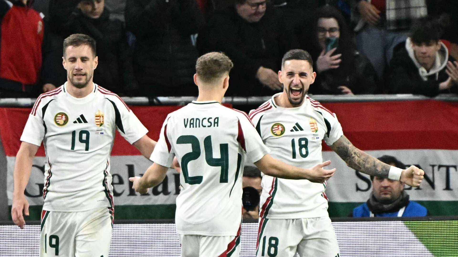Hungary's midfielder #18 Zsolt Nagy (R) celebrates scoring with Hungary's forward #24 Zalan Vancsa and Hungary's forward #19 Barnabas Varga