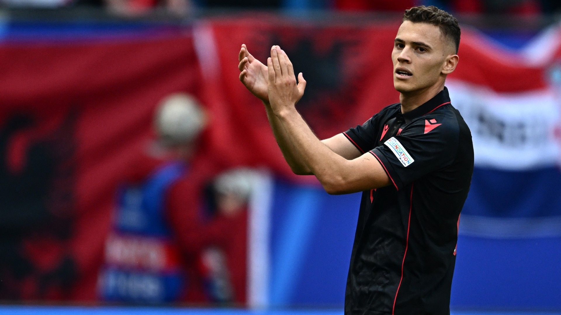 Albania's midfielder #21 Kristjan Asllani reacts