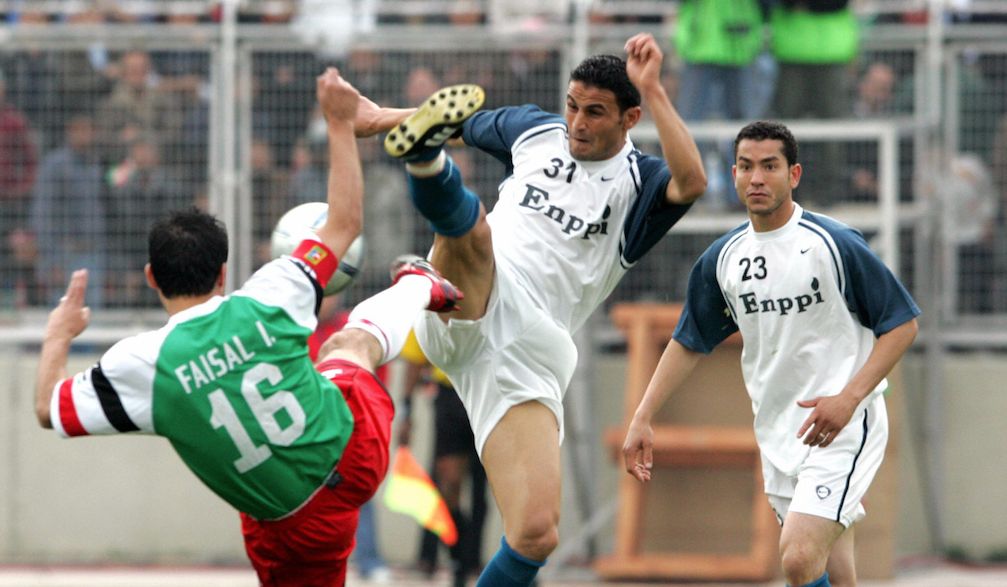Faisal Ibrahim of Jordan's al-Wahdat team (L) vies with Ayman Said of Egypt's Enppi