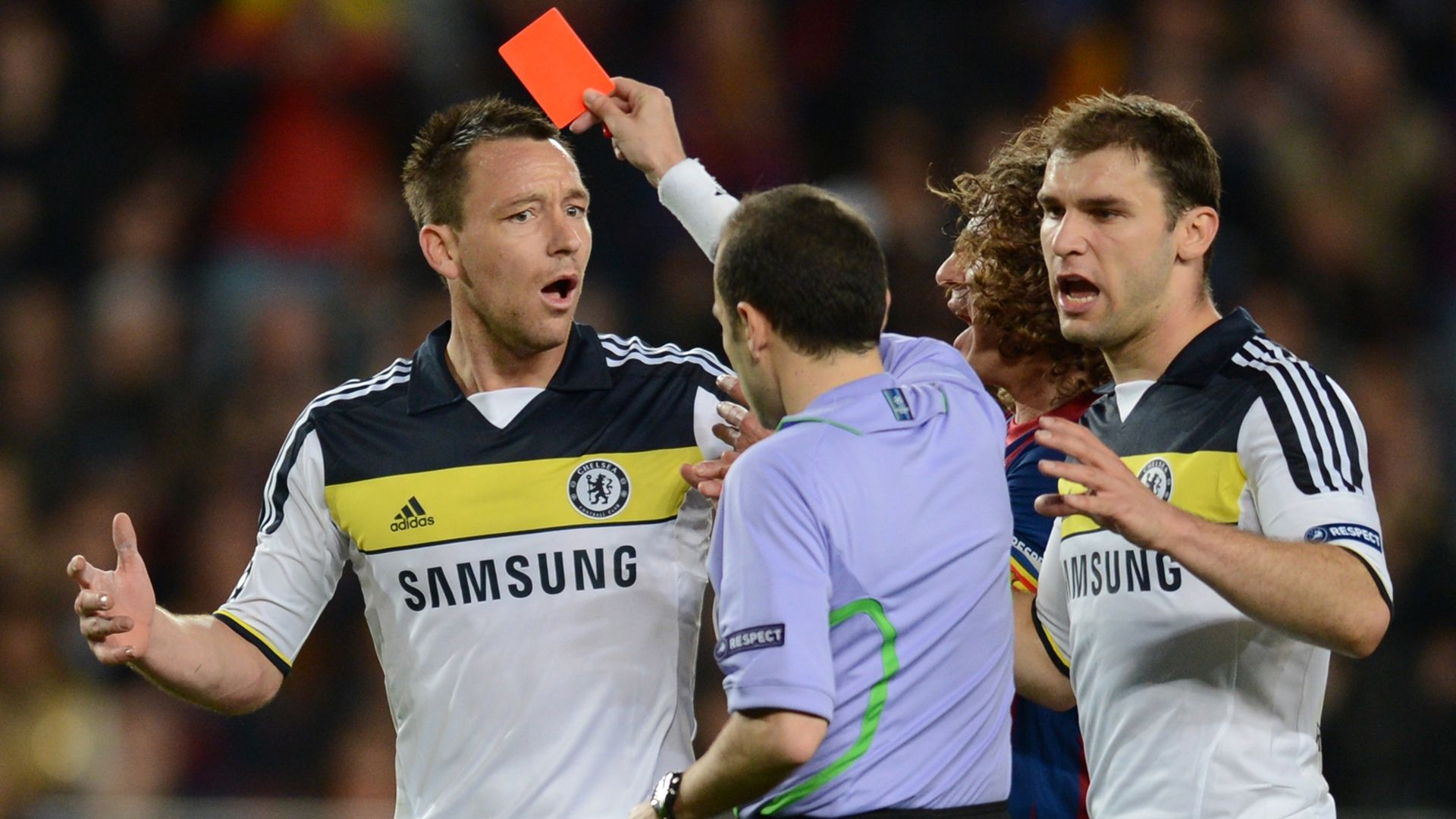 JohnTerry receives a red card from Turkish referee Cuneyt Cakir EFA Champions League second leg semi-final football match Barcelona against Chelsea at the Cam Nou