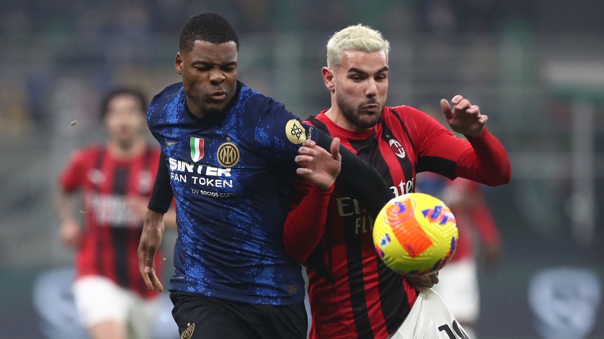 Denzel Dumfries of Internazionale competes for the ball with Theo Hernandez of AC Milan 