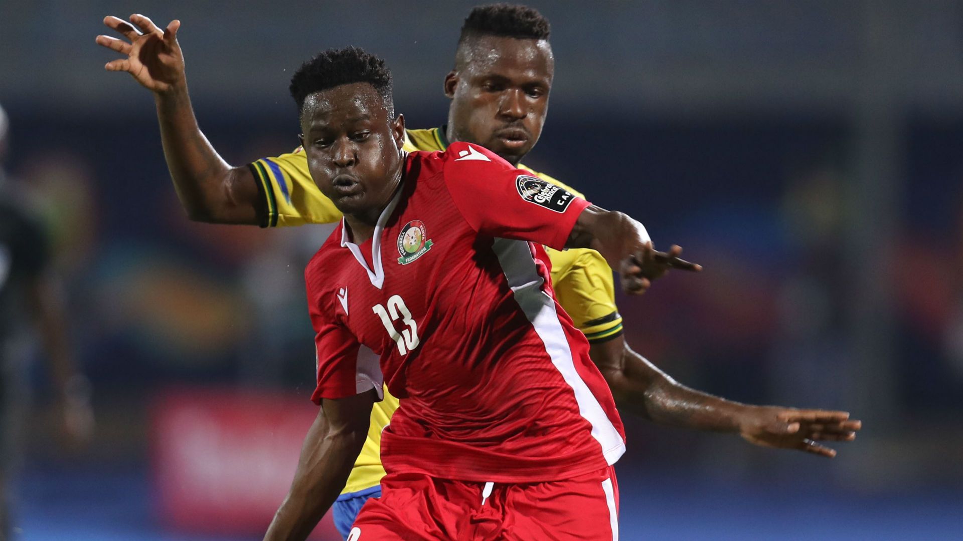 Eric Ouma of Kenya challenged by Thomas Ulimwengu of Tanzania.