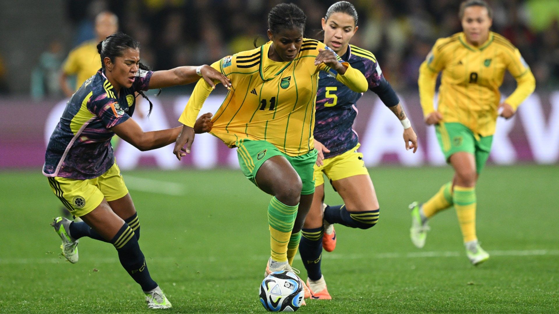 Jamaica's Khadija Bunny Shaw tries to race away from Colombia challenges at the Women's World Cup