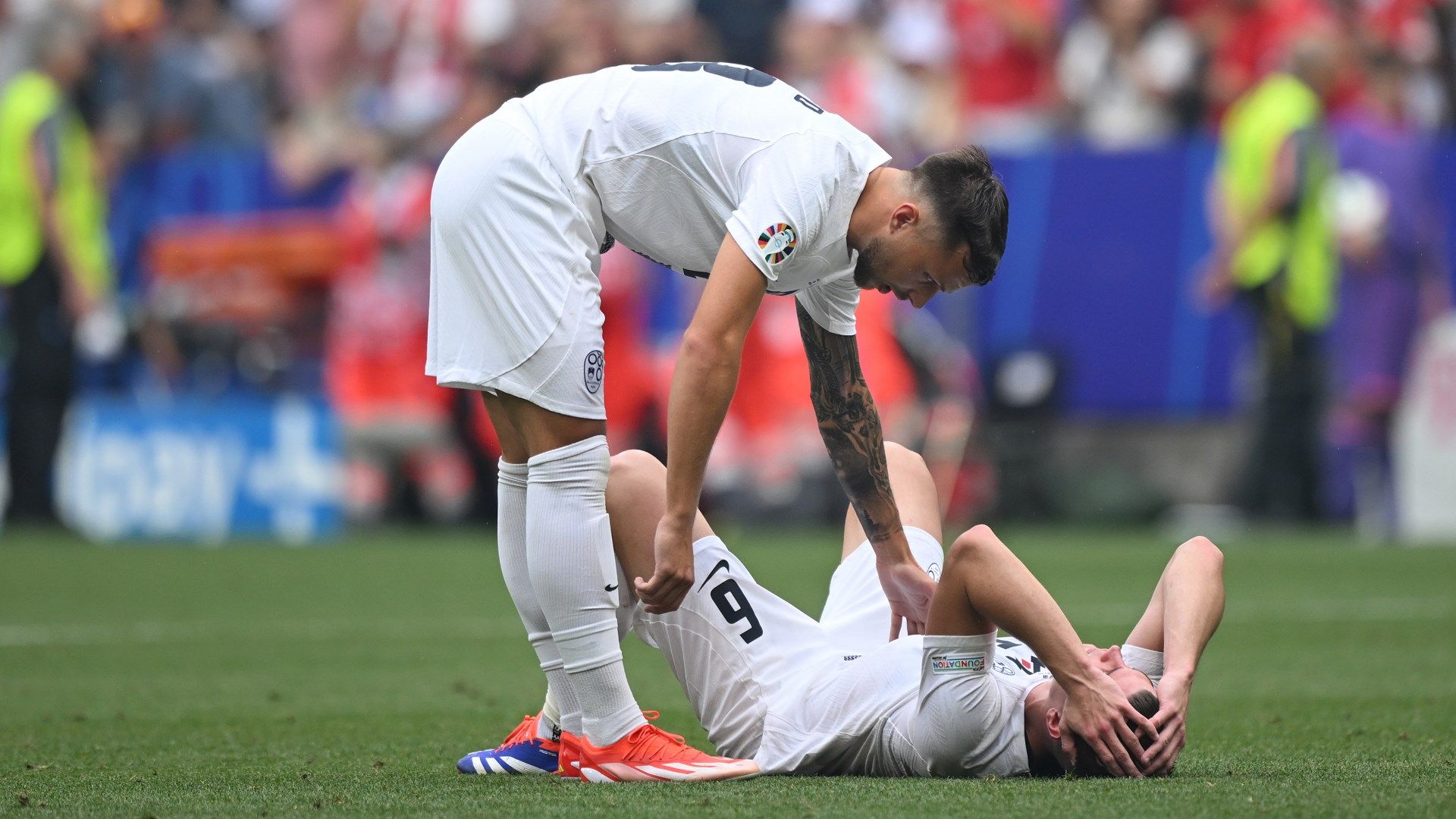 Slovenia look dejected after conceding a late goal against Serbia at Euro 2024