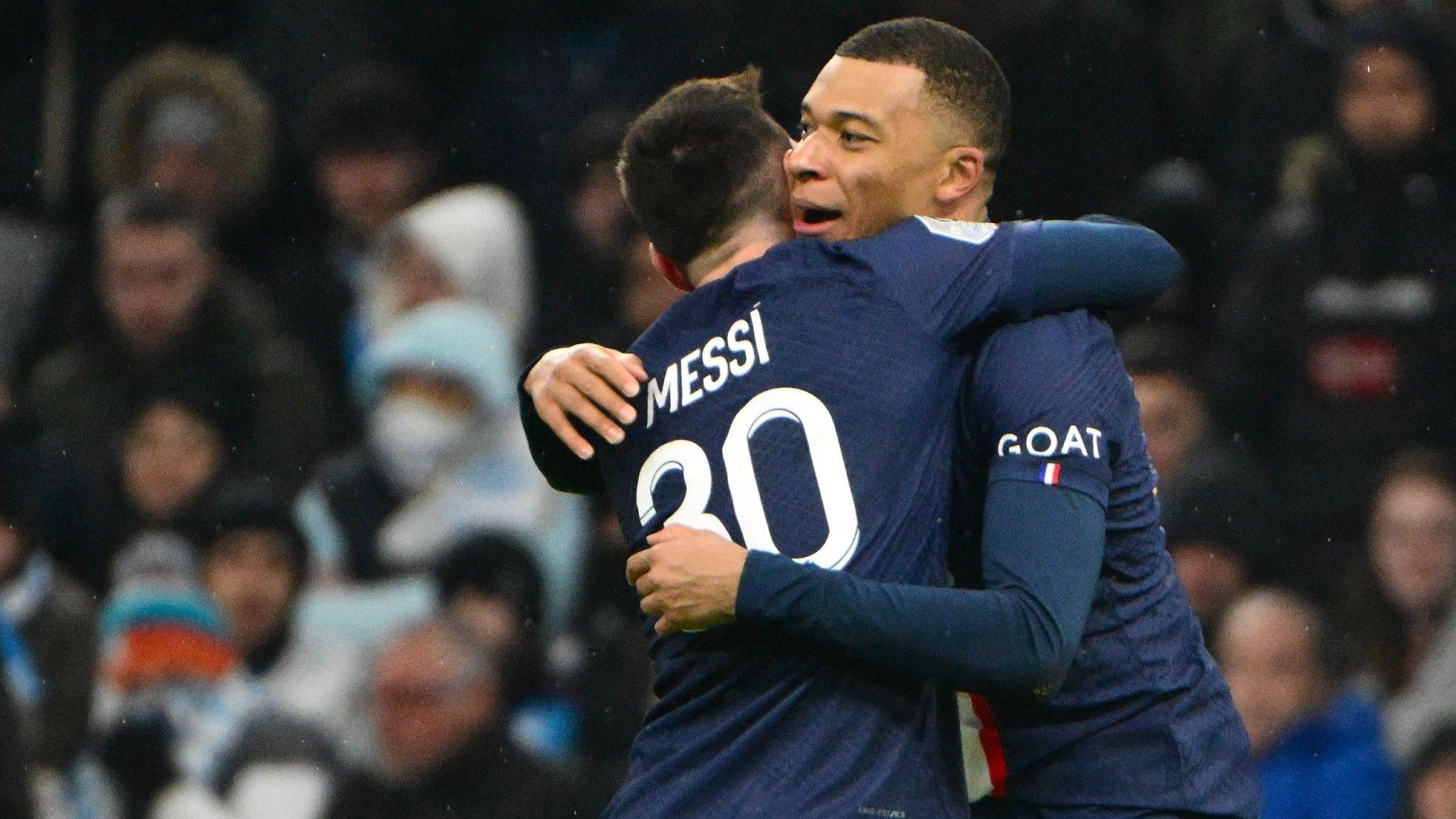 Paris Saint-Germain's French forward Kylian Mbappe (R) is congratulated by Argentine forward Lionel Messi (L)