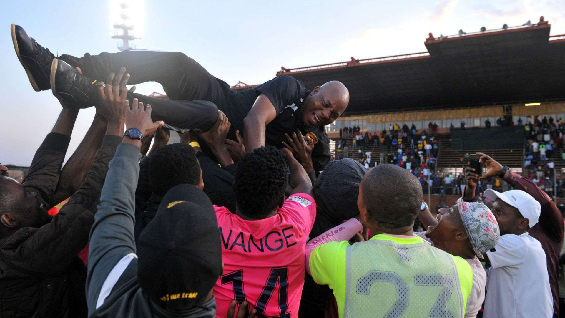 Black Leopards players celebrate with Joel Masutha