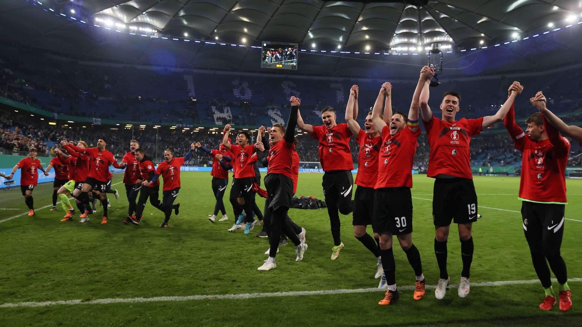 Players of SC Freiburg celebrate their side's progression to the Final of the DFB Cup