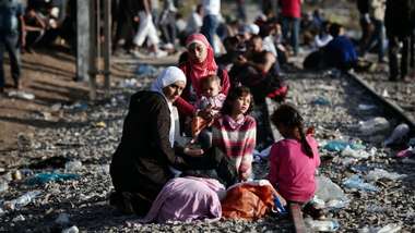 Syrian refugees on a train track