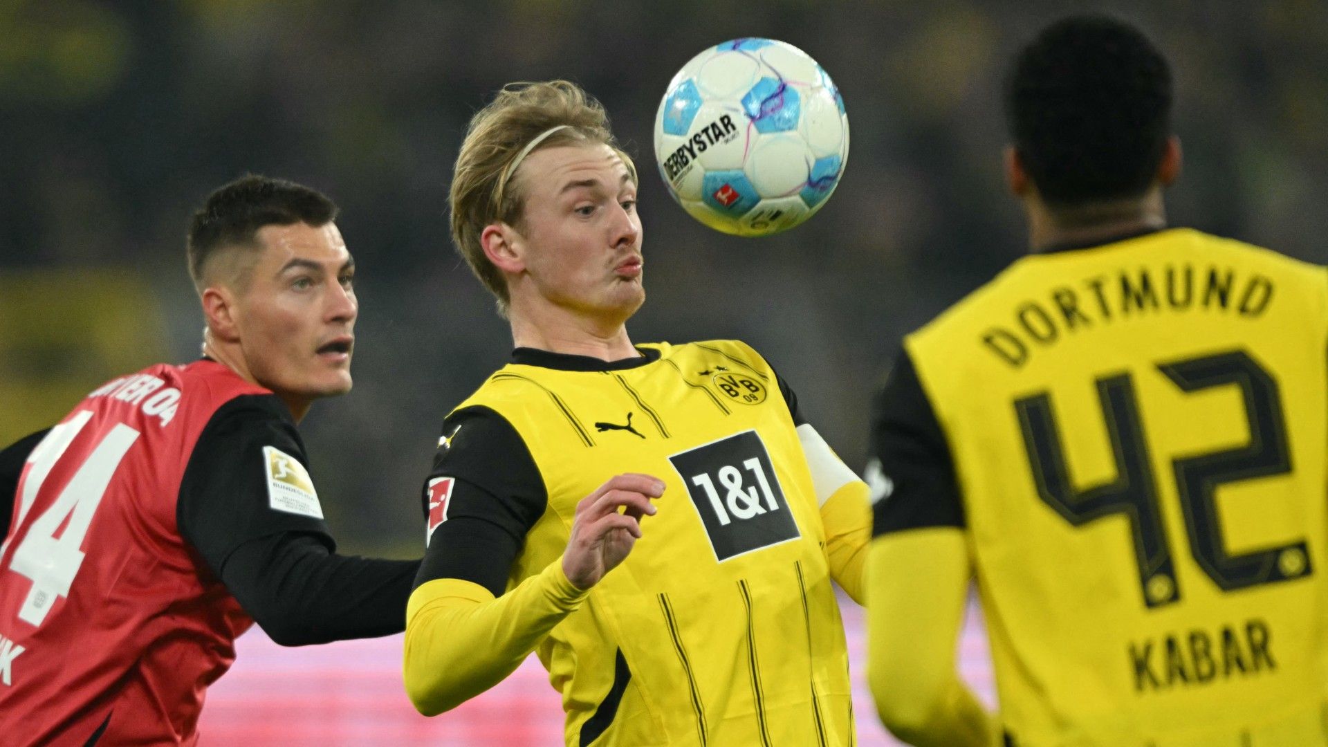 (L-R) Bayer Leverkusen's Czech forward #14 Patrik Schick and Dortmund's German midfielder #10 Julian Brandt (C)