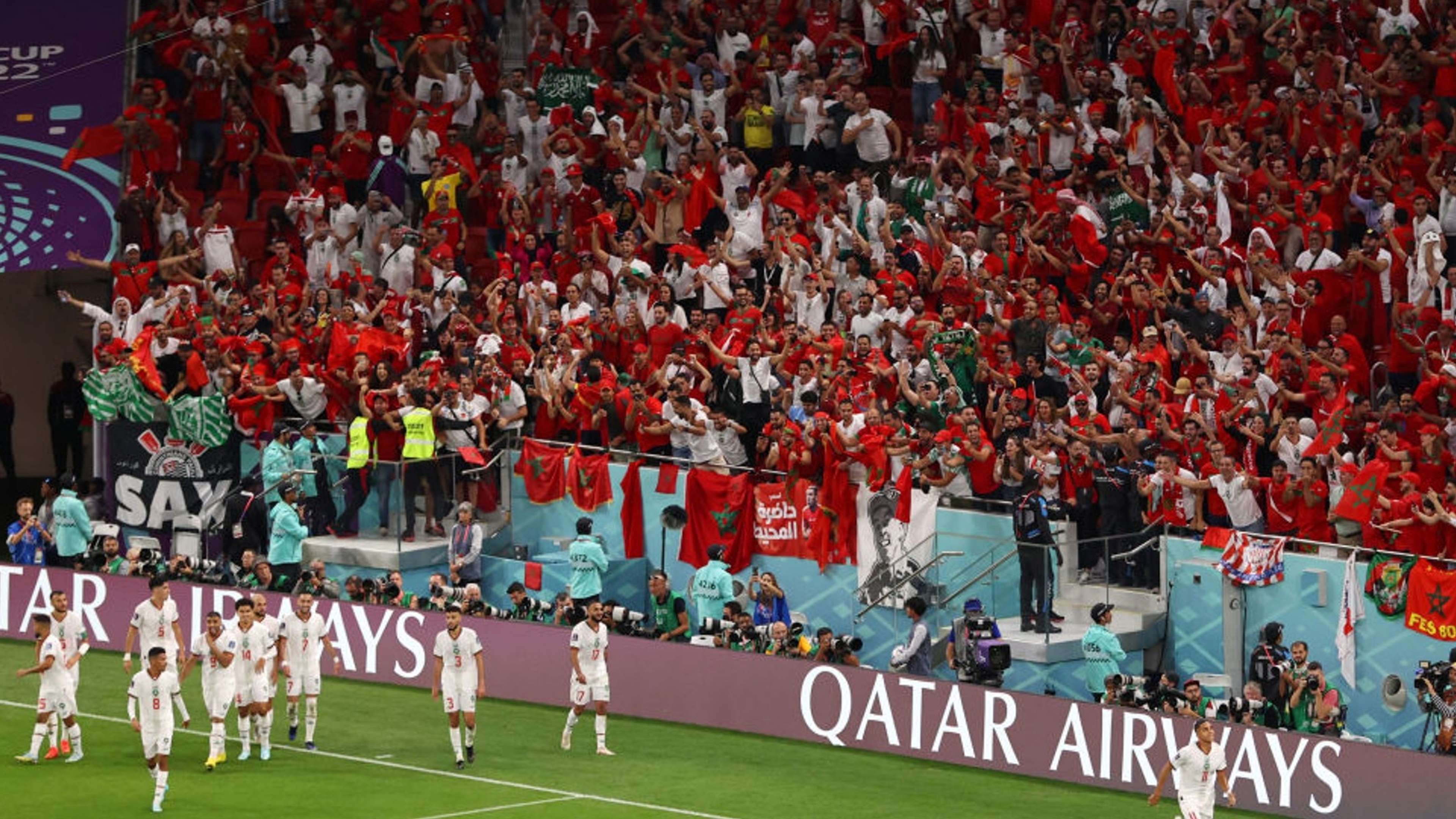 Morocco players celebrate with fans in Qatar.
