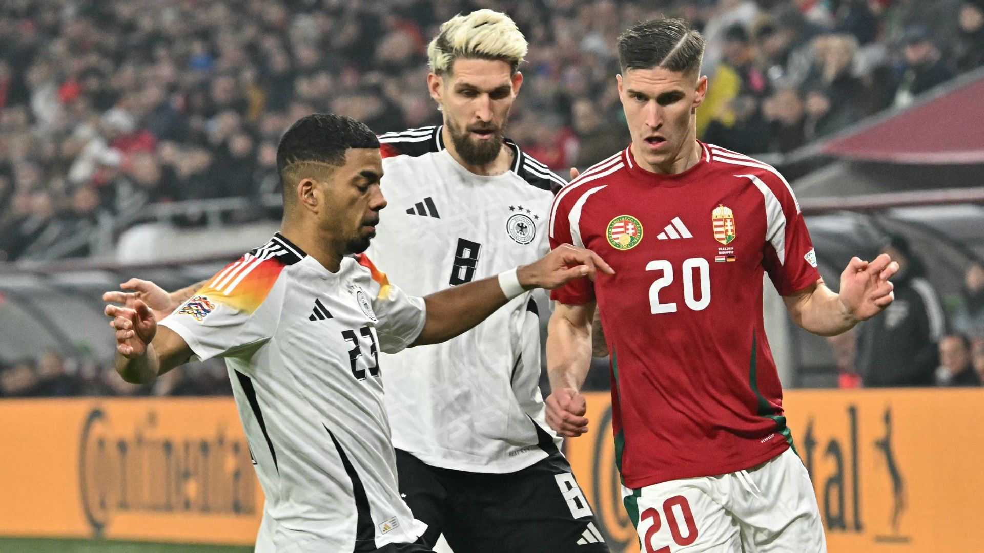 Hungary's forward #20 Roland Sallai (R), Germany's midfielder #08 Robert Andrich and Germany's defender #23 Benjamin Henrichs