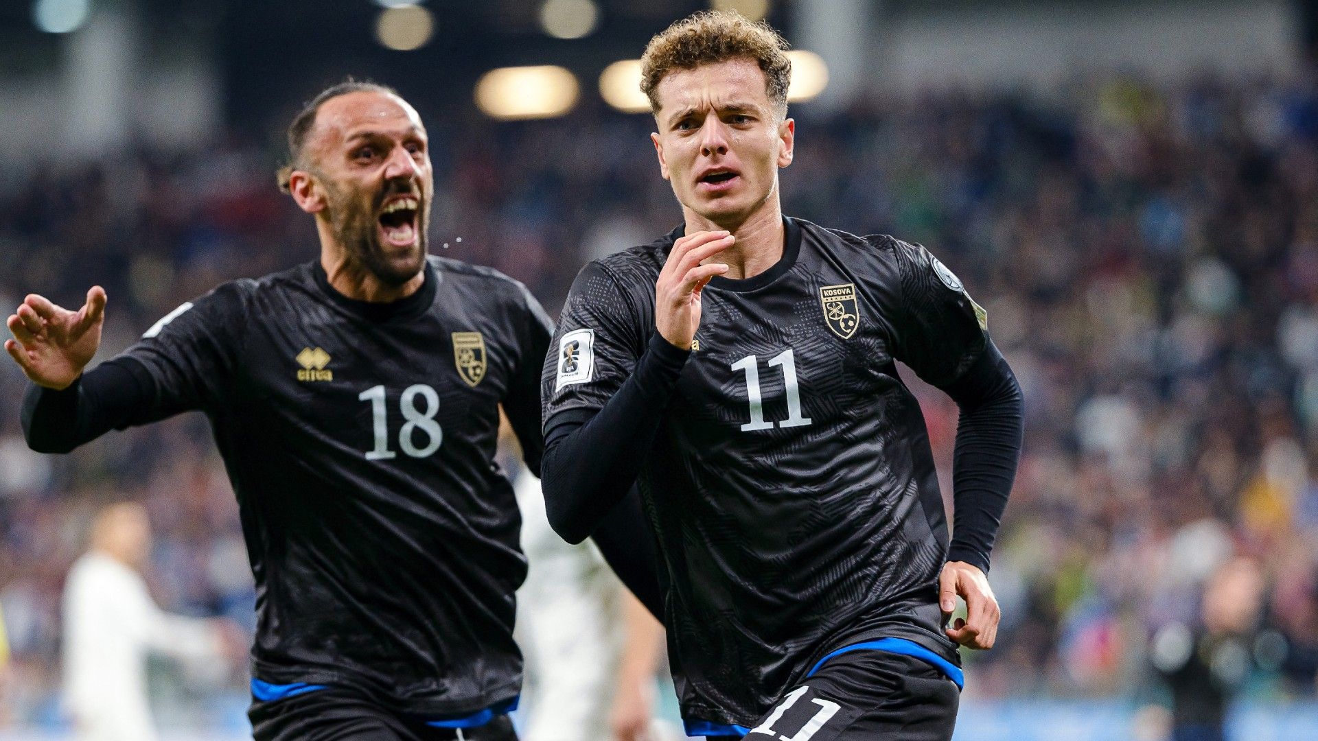 Kosovo's forward #11 Fisnik Asllani (R) celebrates after scoring Kosovo's first goal