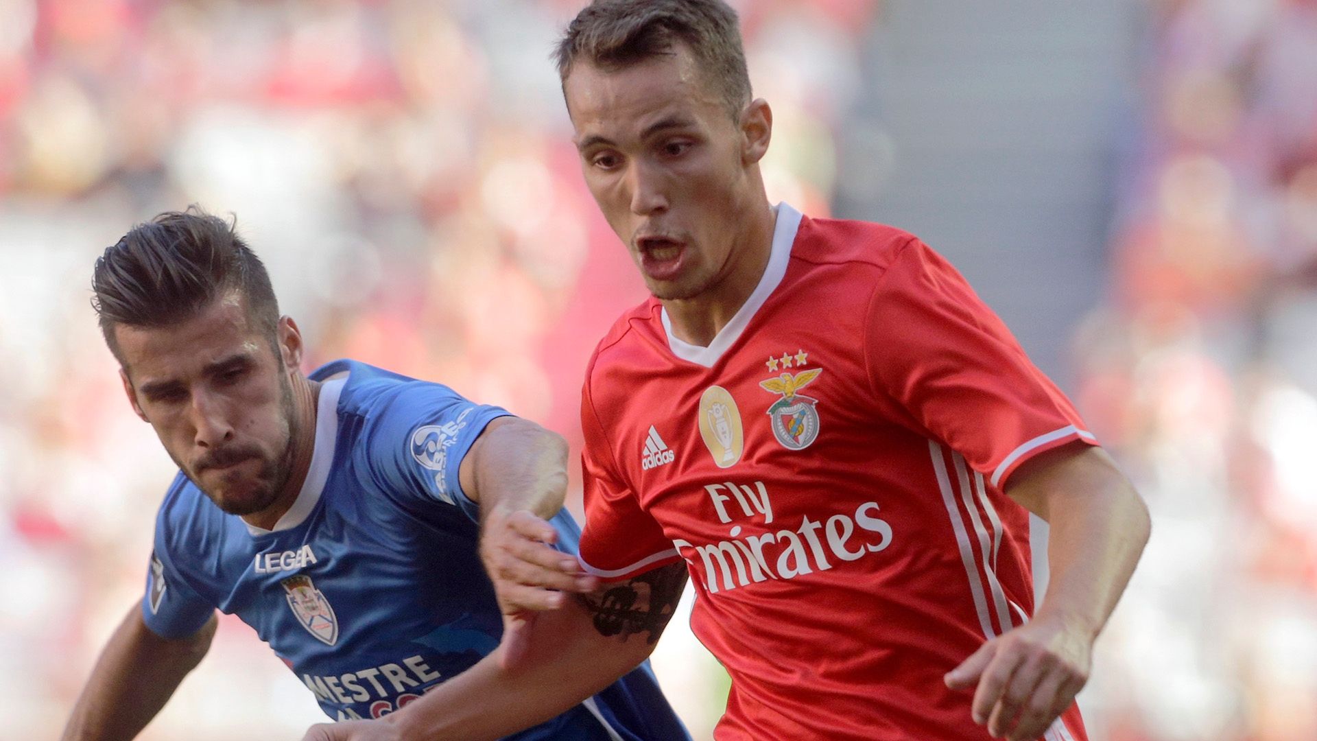 Benfica's Alex Grimaldo (R) with Feirense's Luis Aurelio (L)