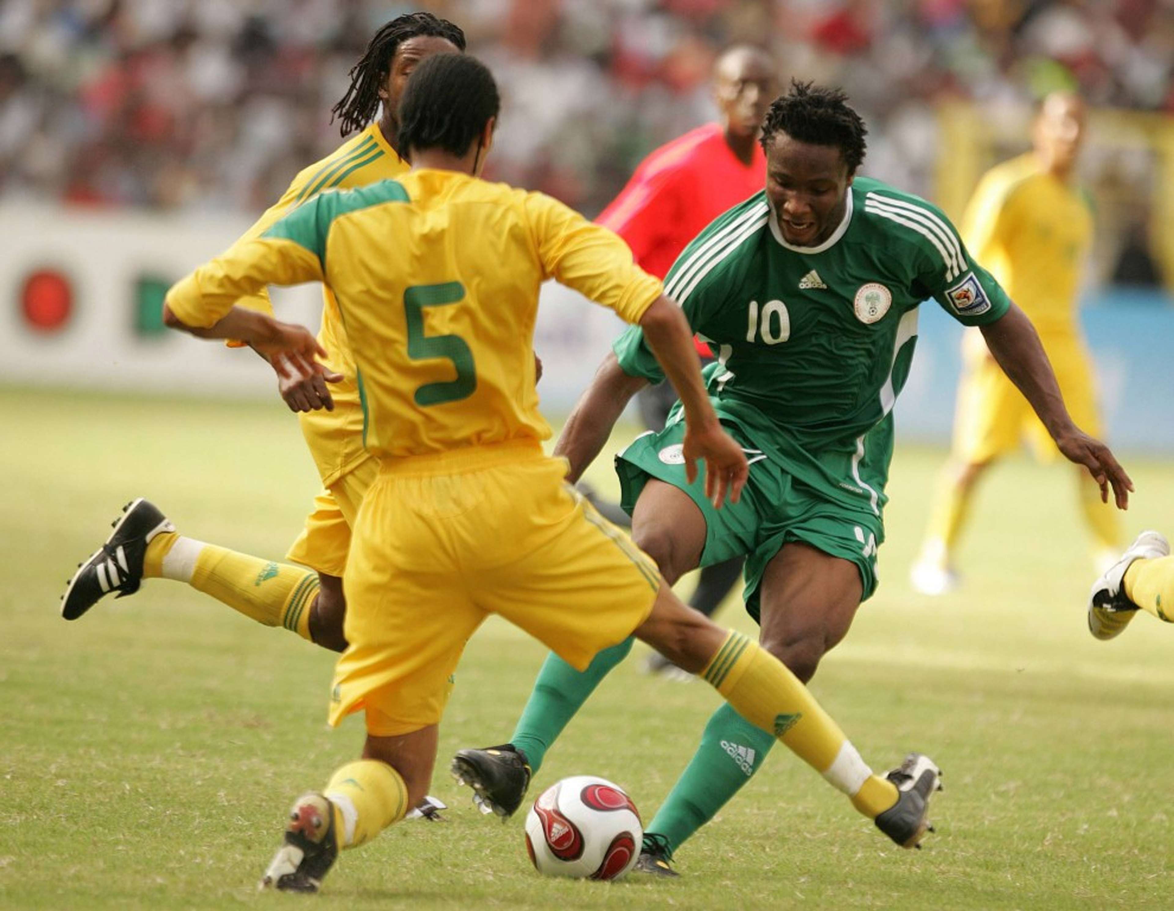 Mikel weaves past South African defenders - South Africa vs Nigeria