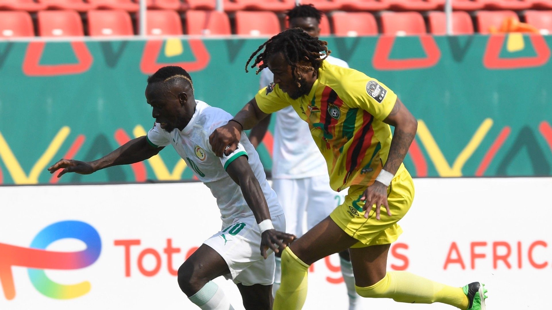 Sadio Mane of Senegal challenged by Leroy Benyu of Zimbabwe.