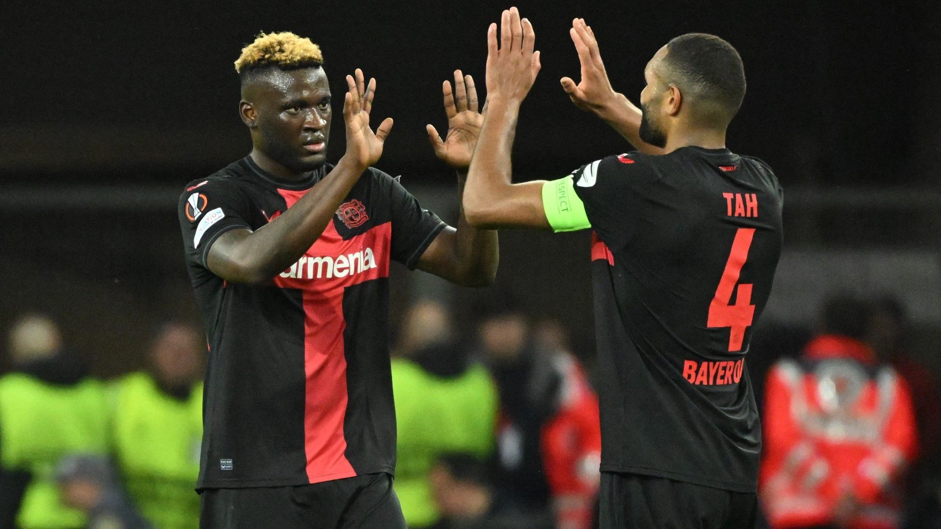 Bayer Leverkusen's Nigerian forward #22 Victor Boniface (L) celebrates scoring his team's second goal with Bayer Leverkusen's German defender #04 Jonathan Tah