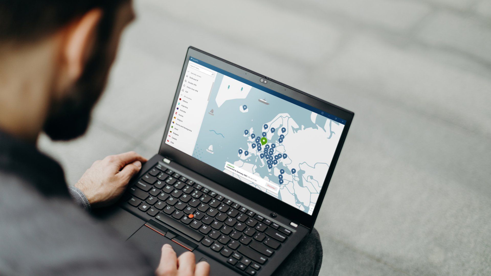 Man on Windows laptop using NordVPN