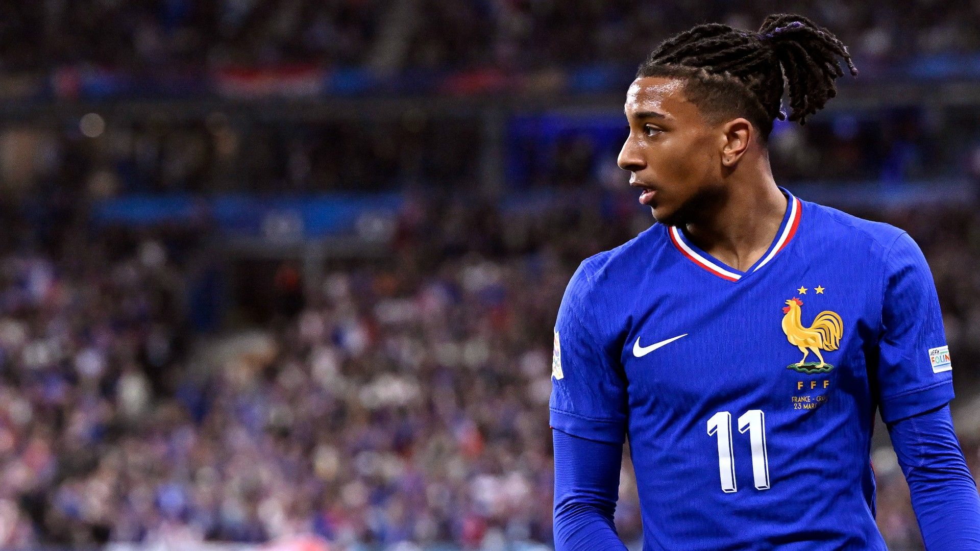 Michael Olise of France looks on 