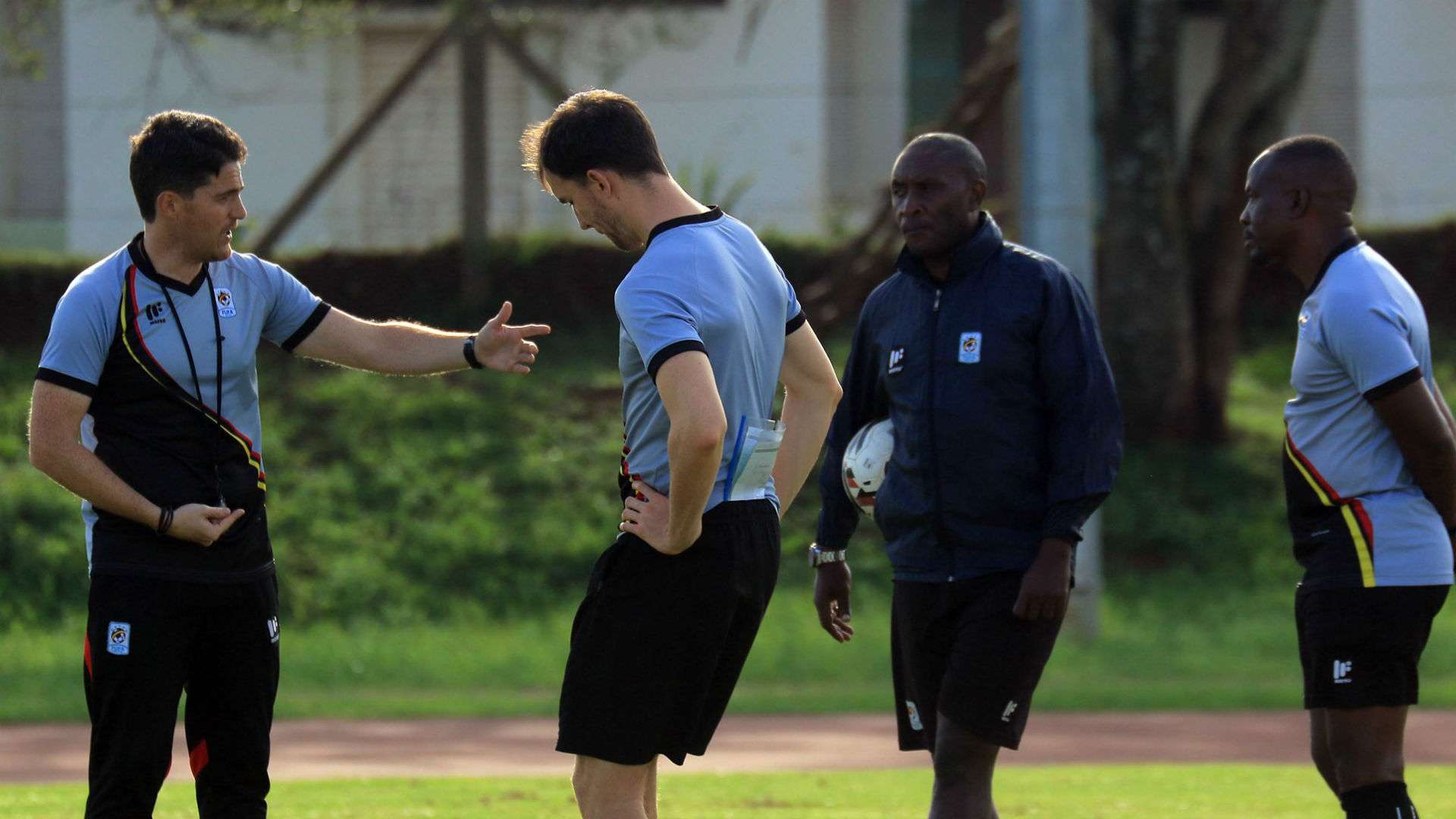 Johnathan McKinstry and Uganda coaches.
