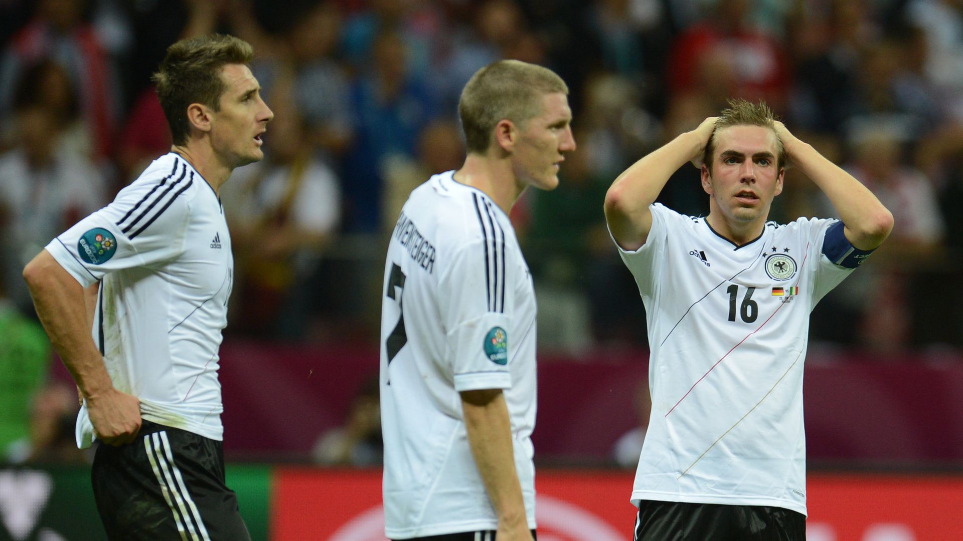 Germany players react to being beaten by Italy in Euro 2012
