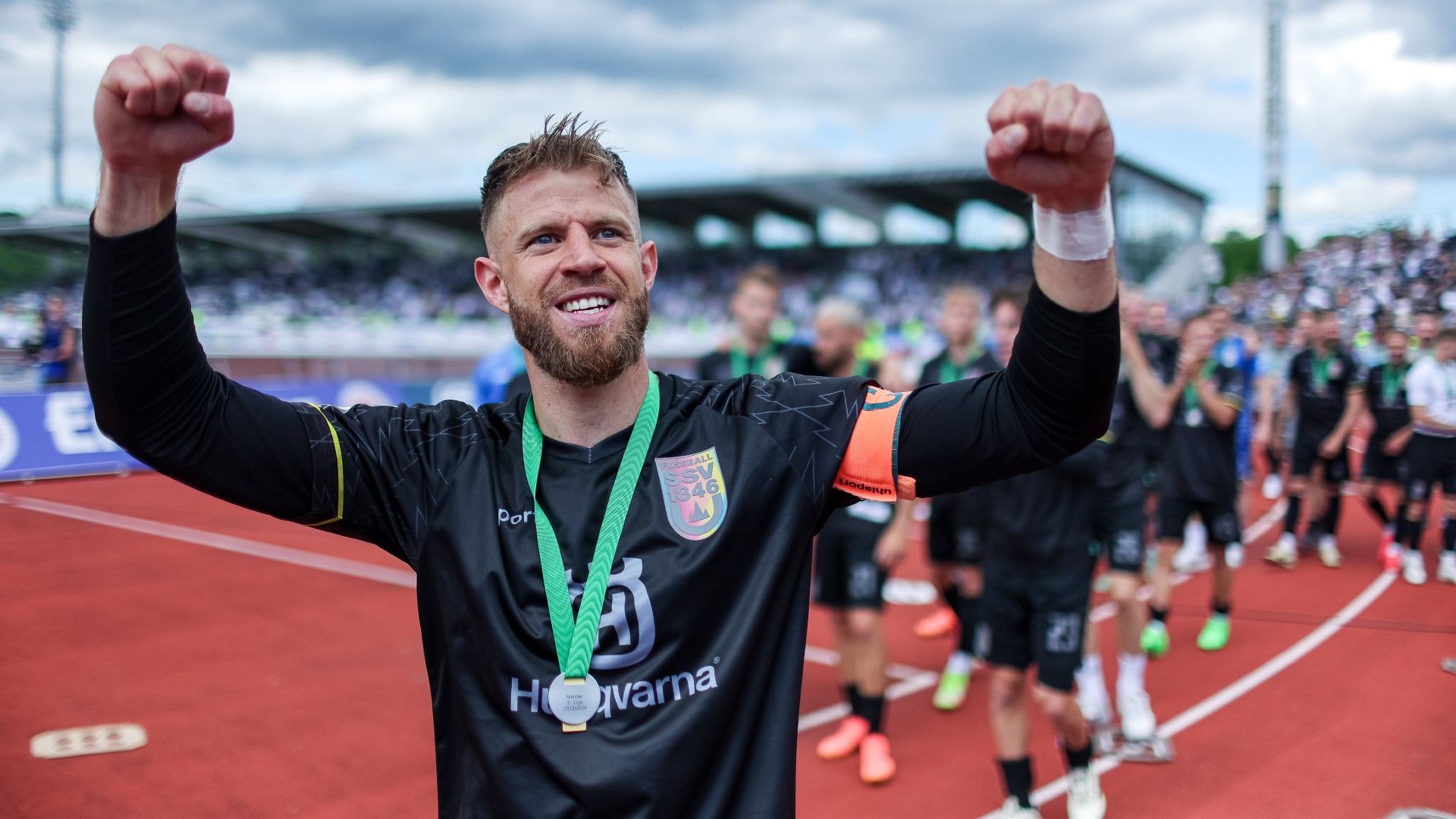 Johannes Reichert and other players of Ulm celebrate with the trophy 