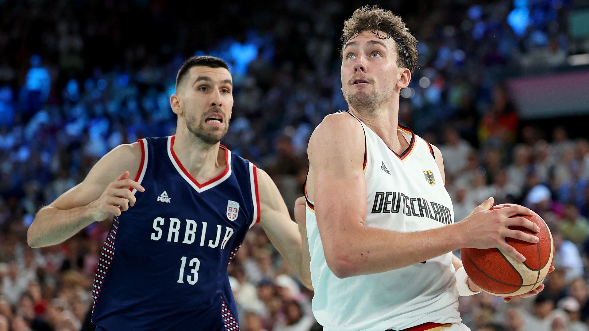  Franz Wagner #9 of Team Germany drives to the basket against Ognjen Dobric #13 of Team Serbia