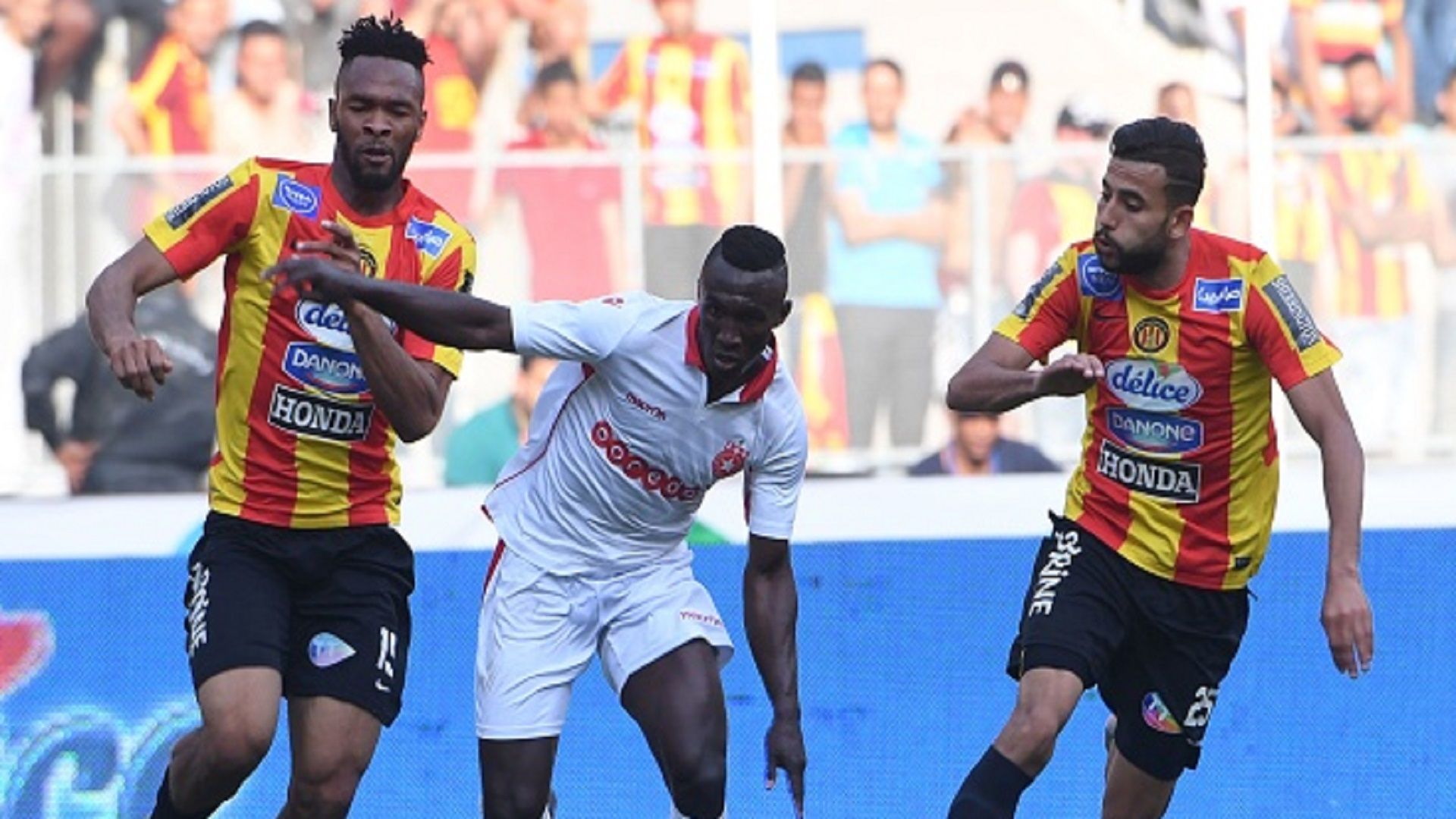 Tunisian Esperance Voussiny Colibaly and Ghailene Chaalali  fight for the ball with Tunisia's Etoile du Sahel Alkhali Bangoura