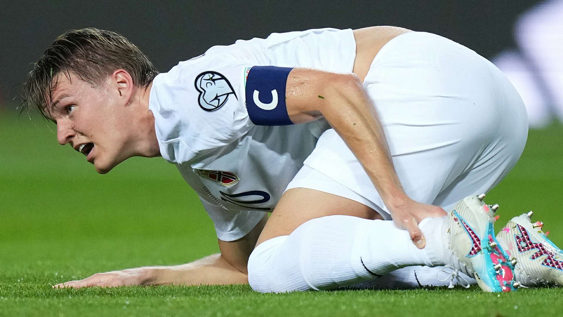 Arsenal captain Martin Odegaard reacts to horror tackle from