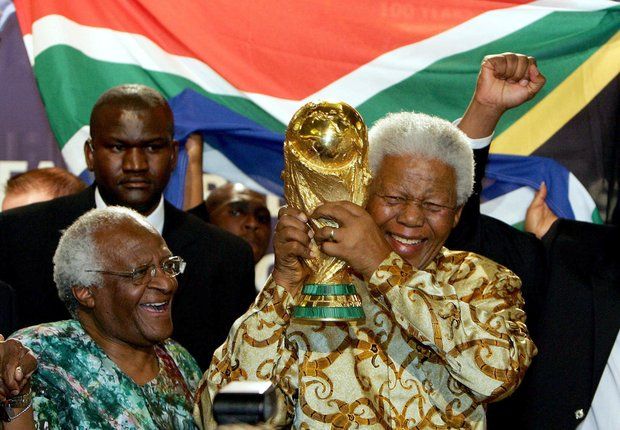 Nelson Mandela holds the World Cup trophy aloft